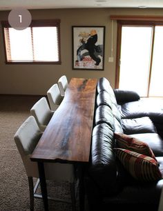 a living room with couches and a wooden table in the middle of the room