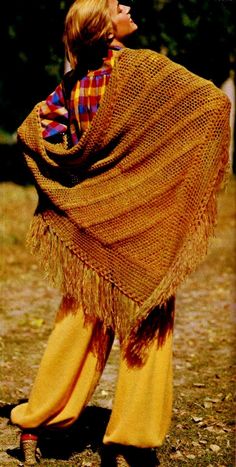 a woman wearing a brown shawl and yellow pants