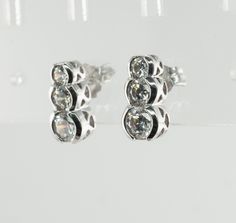 Three Stone Earrings, Genuine Diamond Earrings, Vintage Earrings, 14K White Gold Earrings, Natural Diamond Stud Earrings, Estate Earrings, Everyday Earrings, Elegant Earrings. This vintage pair of earrings is crafted in solid 14K White Gold Three round cut diamonds are .20ct, .15 carat, and .10 carat each = .90 total diamond weight. The diamonds are very clean VS2 clarity and H color. The earrings measure 11mm from top to bottom. They are equipped with long posts and butterfly backs. The pair we Vintage Diamond Earrings, Tiffany Earrings, Earrings Everyday, Three Stone Diamond, Earrings Elegant, White Gold Earrings, Diamond Stud Earrings, Art Deco Diamond, Diamond Stud