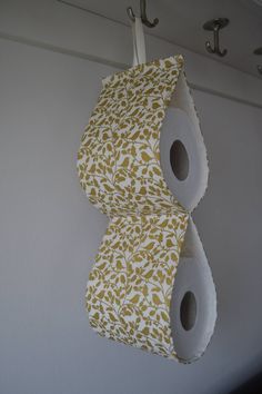 two rolls of toilet paper hanging from hooks