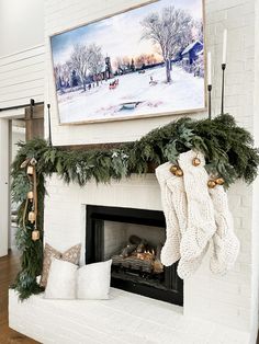 a fireplace decorated for christmas with stockings hanging from the mantle