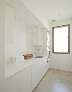 a washer and dryer in a white laundry room