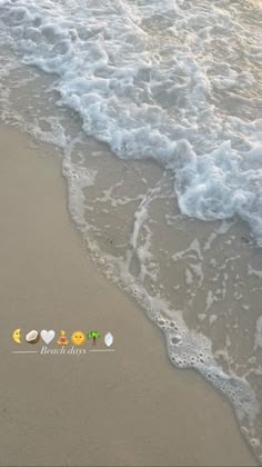 the waves are coming in to the beach and there is a message written on it