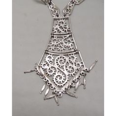 This is part of Chairish’s Costume Jewelry assortment.  Rhodium plated textured openwork 3 part articulated tie like pendant with fringe drops and articulated link chain with hook clasp and extension chain. Marked "Monet" on the hang tag and "Monet©" on the back of the pendant. Pendant measures: 5 inches long by 2 7/8 inches. Chain doubled measures 12 3/4 inches. Excellent condition. From Monet's 1973 Paisley line. A variation on this necklace was featured in a 1973 advertisement. Silver Bohemian Drop Necklace, Elegant Metal Lariat Necklace For Formal Occasions, Formal Metal Pendant Drop Necklace, Elegant Silver Chain Necklace For Festival, Silver Long Drop Jewelry For Festivals, Elegant Drop Necklace With Silver Chain, Elegant Silver Metal Lariat Necklace, Silver Metal Lariat Necklace With Adjustable Chain, Elegant Lariat Necklace For Festivals