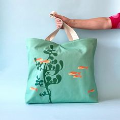 Upgrade your style with our Fish oversized tote bag. Perfect for carrying all your essentials in one stylish package. Get yours today! Oversized Tote Bag, Oversized Tote, Ocean Lover, Cotton Tea Towels, Work Environment, Big Canvas, Sea Life, Retro Inspired