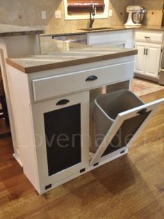 a kitchen with an island that has two trash cans in it and the words home design above it