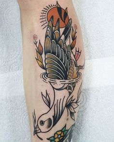 a tattoo on the leg of a person with an eagle and fish in it's beak