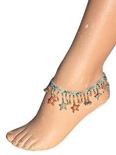 This beautiful Anklet is made entirely with seed beads and features Stars dangling from a patterned band, complimented with tiny bells which have a light jingle. Measuring 10.5 inches in length, this Anklet is adjustable. There are 3 sections to place the button end into.  Each Anklet is made with a mixture of 5 beautiful colours! This one has: Clear Dark Green Frosted Hot Orange Irridescent Turqoise Transparent Peach Smokey Saphire And Silver Tone Bells Silver Beaded Festival Anklets, Festival Silver Beaded Anklets, Silver Beaded Anklets For Festival, Adjustable Silver Bead Anklet For Festivals, Adjustable Silver Beads Anklet For Festival, Adjustable Silver Beaded Anklet For Festivals, Festival Anklets With Silver Beads, Multicolor Beaded Anklets For Festivals, Bohemian Festive Anklets With Silver Beads