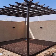 an outdoor patio with a wooden deck and pergolated roof