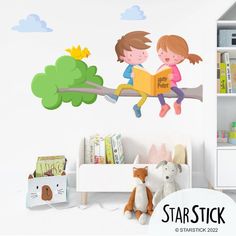 two children sitting on a tree branch reading a book wall decal in a child's room