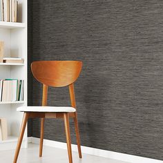 a chair sitting in front of a book shelf