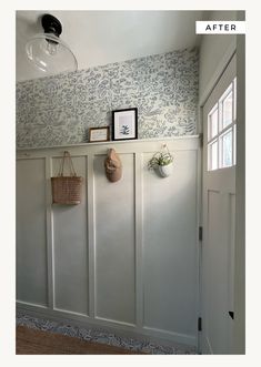 an empty room with white paneling and blue wallpaper