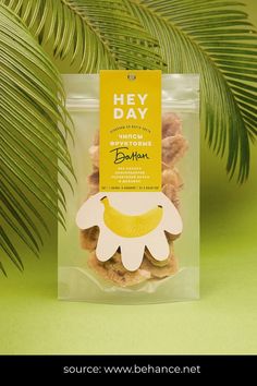 a package of cookies with banana and flower on the top, sitting in front of a palm tree