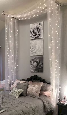 a bedroom decorated with lights and pictures on the wall