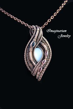 "This spectacular pendant has contributed to the winning of several awards at art festivals. The central stone is a natural white shimmering moonstone and it is accented to the left by a large teardrop blue sapphire and to the right by three sparkling oval pink tourmalines. The pendant is made by creating a frame and then attaching sections of wire that have been wrapped and woven together. It includes a textured 28\" solid copper chain. The copper has been coated with an anti-tarnish sealant to Wire Wrapped Stone Jewelry, Wire Wrap Jewelry Designs, Diy Jewelry Inspiration, Wire Jewelry Designs, Oxidized Copper, Palm Coast, Wire Wrapping Stones, Hand Bracelet, White Moonstone