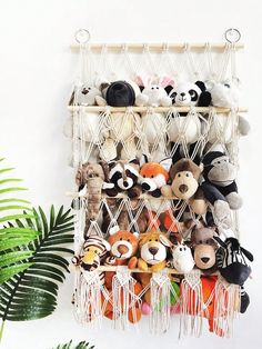 there is a rack with stuffed animals hanging from it's sides on the wall