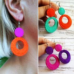 the earrings are made out of felt and have colorful circles hanging from each earring