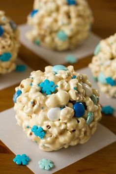 there are some cupcakes that have blue and white frosting on them with sprinkles