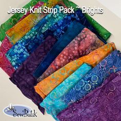 a bunch of different colored fabrics sitting on top of a white tablecloth with the words jesey kit strip pack brights