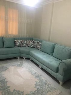 a living room with a blue couch and rug