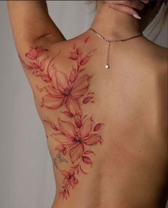 The photo shows a red tattoo placed on women back, desing of tattoo is flowers with a little abstraction and leafs around them, its good inspiration for modern tattoo for women Red Dragon Tattoo For Women, Flowers Tattoo On Back, Tattoo On Back For Women, Red Tattoo On Black Women, Red Flowers Tattoo, Backpiece Tattoo, Red Dragon Tattoo, Tattoo On Back, Dragon Tattoos