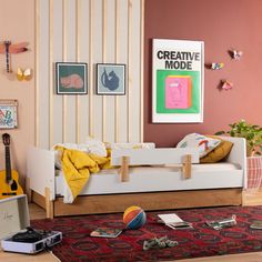 a living room with a couch and guitar on the floor