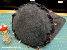 a large gray bag sitting on top of a cutting board next to a small bowl