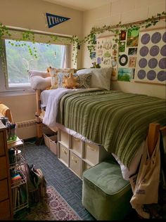 a bedroom with a bed and lots of storage boxes on the bottom floor, next to a window