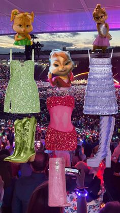 there are many dresses hanging in the air at a concert with other people watching them