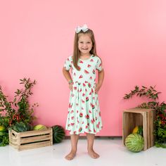 Girl wearing Kyte Baby Twirl Dress in Watermelon Spring Twirl Dress For Playwear, Flowy Casual Twirl Dress For Playtime, Casual Flowy Twirl Dress For Playtime, Comfortable Casual Twirl Dress For Playtime, Summer Flowy Twirl Dress For Playdate, Flowy Twirl Dress For Summer Playdate, Cute Summer Twirl Dress For Playwear, Playful Pink Flowy Twirl Dress, Playful Twirl Dress For Summer Playdate