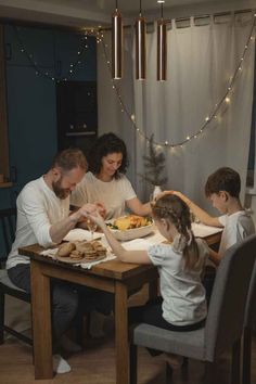 a family sitting around a table eating food