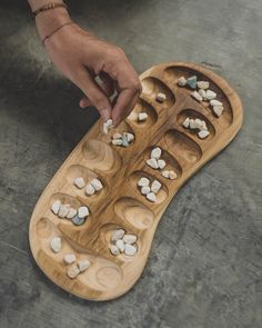 Mancala games are a family of turn-based strategy board games for two players played with small stones, beans or seeds and a series of holes or openings in the ground, board or other playing surface. The goal is usually to capture all or some set of the opponent's pieces. Each game is unique, so we give you the opportunity to see all the options available. You can choose the exact commission before or after your purchase. HOW TO PLAY https://www.youtube.com/watch?v=OX7rj93m6o8 We use FedEx for delivery. So you can receive your game in 3-7 business days. Homemade Xmas Gifts, Mancala Board, Pottery Games, Mancala Game, Board Games For Two, Homemade Board Games, Strategy Board Games, Wood Games, How To Make Clay