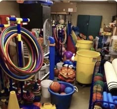 a room filled with lots of different types of rubber bands and buckets on the floor