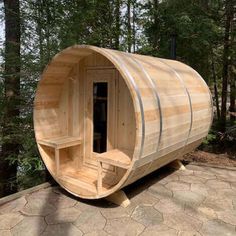 a wooden sauna in the middle of a wooded area