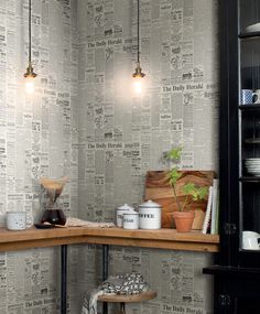 a kitchen with newspaper wallpaper and wooden shelves