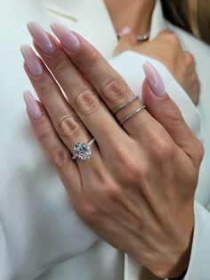 a close up of a person's hands with two rings on their fingers and one ring in the other hand