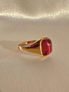 Antique 18k yellow gold ring from the United Kingdom. This signet ring features a vibrant synthetic ruby cabochon. Great antique condition Size: 7.5 resizable* Weight: 3.5 grams Band: 11.1 mm (front), 1.7 mm (back) Synth Ruby: 8.3 mm x 10.0 mm Hallmarks:18CT 18k Yellow Gold Ring, Yellow Gold Ring, Signet Ring, Yellow Gold Rings, Gold Ring, United Kingdom, Gold Rings, Ruby, Yellow Gold