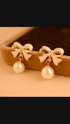 Add a touch of charm to your outfit with our Adorable Pink Bow and Pearl Earrings. These sweet and stylish earrings feature delicate bows and elegant pearls, perfect for any occasion. Elegant White Jewelry With Pink Bow, Party Jewelry With Pink Bow In White, White Jewelry With Pink Bow For Party, Feminine Pearl White Pearl Earrings For Party, White Party Jewelry With Pink Bow, Elegant Rose Gold Bow Earrings, Elegant Rose Gold Earrings With Bow, Feminine Bow Earrings For Formal Occasions, Feminine Pearl Drop Earrings