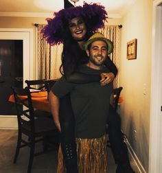 a man and woman dressed up in costume posing for the camera while they both have their arms around each other