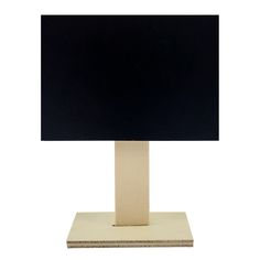 a black and white computer monitor sitting on top of a wooden stand