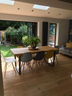 a dining room table with chairs and a potted plant