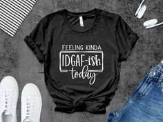 Embrace your carefree spirit with this bold 'Feeling Kinda IDGAF-ish Today' T-Shirt. Perfect for those days when you just want to make a statement without saying a word, this comfy tee with its striking black and white design is sure to become a go-to in your casual wardrobe. Made with high-quality materials, it's not only stylish but also durable and easy to care for. Whether you're lounging at home, meeting up with friends, or running errands, this unisex shirt's relaxed fit is suitable for al Slogan T-shirt For Alternative Fashion, Black T-shirt With Text Print For Alternative Fashion, Antisocial Tshirts, Feeling Idgaf-ish Today Svg, Gaslighting Isn't Real You're Just Crazy Shirt, White Heat, Quote Tees, T Shirts With Sayings, Graphic Shirt