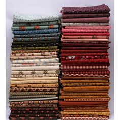 a pile of different colored fabrics sitting on top of each other