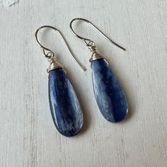 These kyanite teardrop briolette beads are a fantastic medium blue color with terrific sheen.  I gave them a wrapped sterling silver top and suspended them on my handmade sterling silver hook ear wires.  These earrings are 1 5/8 inches long from the top of the hook. Here's an entrance to my shop - http://www.etsy.com/shop/TheTwistedPretzel Blue Teardrop Jewelry For Everyday, Everyday Blue Teardrop Earrings With Ear Wire, Everyday Blue Earrings With Natural Stones, Handmade Blue Pear-shaped Jewelry, Blue Wire Wrapped Teardrop Earrings Gift, Blue Teardrop Earrings With Ear Wire, Blue Gemstone Teardrop Dangle Earrings, Blue Gemstone Teardrop Earrings, Blue Long Drop Teardrop Earrings Gift