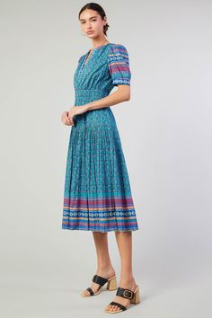 This split-neck midi dress serves as the canvas for a harmonious meetup of prints. Framed by a geometric border, the pleated number has an abstract floral motif that's a delight for the modern bohemian. •Split neckline •Lined •Short sleeves •Elasticized waist •Pleated skirt •Mid-length hem DIMENSIONS •Standard: 49.25" Length Item number 2490244 100% Cotton Lining 75% Rayon 25% Polyester Dry cleanItem number 2490244 Bohemian Midi Dress, Geometric Border, Multicolor Dress, Mother Denim, Modern Bohemian, Romper Dress, Blue Midi Dress, Romper With Skirt, Trending Dresses