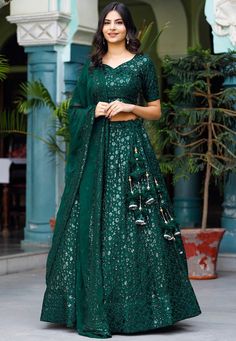 Readymade Faux Georgette Lehenga in Dark Green. This attire with Cotton and Shantoon Lining is Enhanced with Enhanced with Fancy Tassels, Resham and Sequins Work Available with a Faux Georgette Dark Green Choli Crafted in Sweetheart Neck and Half Sleeves and a Faux Georgette Dupatta in Dark Green. The Choli and Lehenga Lengths are 15 and 42 inches respectively Do Note: Accessories shown in the image are for presentation purposes only. (Slight variation in actual color vs. image is possible). We Navratri Green Embellished Lehenga, Green Embellished Lehenga For Navratri, Embellished Green Lehenga For Navratri, Green Embellished Sets For Navratri, Green Embellished Lehenga For Festivals, Embellished Green Lehenga For Festive Occasions, Festive Green Embellished Lehenga, Festive Embellished Green Lehenga, Festive Green Embellished Choli