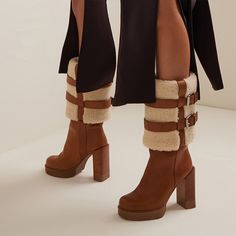 These mid-calf booties feature a comfortable round toe design, lambswool lining for extra comfort, and a chunky heel for stability and a touch of elegance. The rich brown suede exterior exudes a timeless appeal, effortlessly complementing any outfit. Its platform design not only enhances your stature but also provides added comfort for all-day wear. Perfect for cold-weather fashion or a stylish statement piece, these boots are sure to become a beloved staple in your footwear collection. Style: m Winter Knee-high Platform Boots With Lug Sole, Brown Knee-high Boots For Winter, Brown Winter Mid-calf Boots, Winter Brown Knee-high Platform Boots, Winter Brown Mid-calf Boots With Reinforced Heel, Winter Knee-high Brown Platform Boots, Fall Boots With Faux Fur Lining, Brown High Heel Platform Boots For Winter, Winter Heeled Boots With Reinforced Block Heel