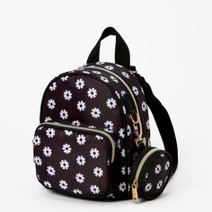 Don't let this backpack's small size fool you... it's big on style! Classic black goes with just about anything, and the white daisy print is fresh and festive for spring or anytime of the year. Stash your essentials in one of the two zippered compartments; there's also a matching coin purse that you can attach with the carabiner clip. Carry it with the top handle or wear it backpack-style. The shoulder straps are adjustable for a comfortable fit. Adjustable straps Backpack Dimensions: 6" W x 8" White Backpack With Zipper Closure For Spring, Spring Backpack With Zipper Closure For Daily Use, Black Backpack For Spring, Spring Backpack With Zipper Closure, Small Travel Backpack, Cute Backpacks For School, Big Backpacks, Cute Mini Backpacks, Stylish School Bags