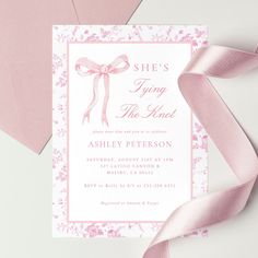 a pink and white card with a ribbon on it