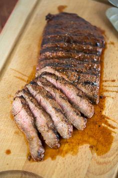 a piece of steak is sitting on a cutting board